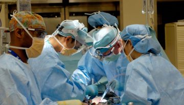 A group of doctors or surgeons operating at a table