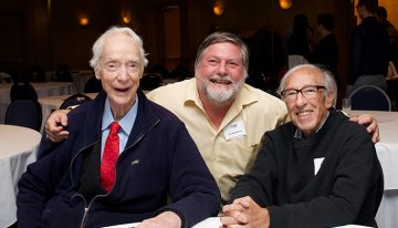 Group photo of Dr. Earl W. Davie, Dr. Ross MacGillivray and Dr. Eddy Fischer (from left to right) seated at a table during the Earl W. Davie Symposium in 2017.