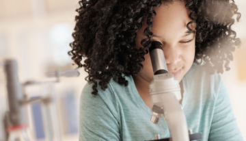 Child looking through microscope